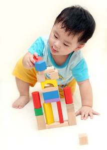 Asian toddler building block tower Dreamstime
